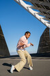© Alba Vitta/Stocksy - Young trendy man dancing outdoors