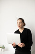 © Lauren Lee/Stocksy - Woman holding open laptop