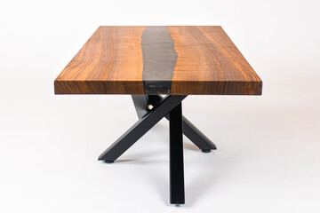Poster - Curly Bastogne Walnut wooden coffee table with black epoxy resin and metal legs. White studio backdrop.