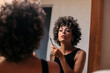© Lucas Ottone/Stocksy - Young woman applying mascara