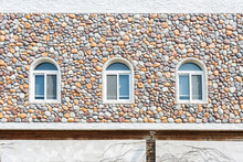 House With Stone Wall And Small Windows