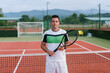 © STUDIO TAURUS/Stocksy - Smiling tennis coach holding racquet on tennis court