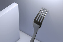 Metal fork leaning against the wall