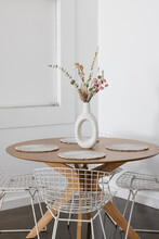 Round Dining Table With Vase Of Flowers 