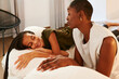 © Ivan Gener/Stocksy - Mom and little girl talking on a bed