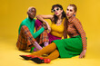 © BONNINSTUDIO/Stocksy - Trendy women in colorful retro clothes