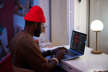 man coding on his laptop
