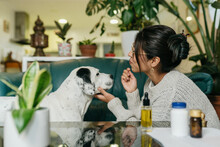 Woman Giving Dog His Medicine