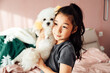 © MaaHoo Studio/Stocksy - Cute Asian girl playing with puppy