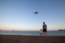Beach Travel, Father And Child Looking At Airplane
