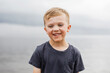 © Kelly Knox/Stocksy - portrait series of a boy by a lake