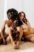 Three Women With Their Hair Full Of Decorative Flowers
