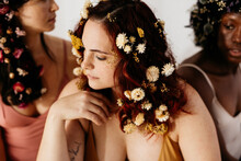 Three Women With Their Hair Full Of Flowers