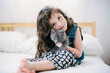 © Stacy Allen/Stocksy - Young Girl holding a gray kitten