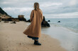 © Olga Moreira/Stocksy - Back view of a woman on winter beach