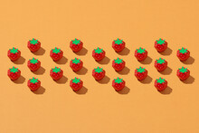 Textured Pattern With Handmade Paper Strawberries Isolated On Orange Background