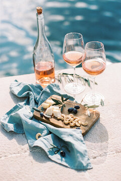 rose wine with cheese and nuts by the sea