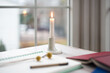 © Lauren Lee/Stocksy - Single candle burning on table