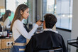© Javier Pardina/Stocksy - Hairdresser with a client