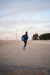 © Javier Díez/Stocksy - Runner jogging in hilly terrain