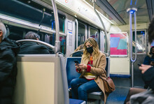 A Woman With A Mask In Public Transport