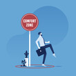 Exit from the comfort zone concept, businessman carefully stepping out of a comfort zone
