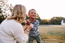 Mom Clapping With Young Son, Who Has Down Syndrome