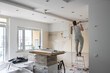 © Hernandez & Sorokina/Stocksy - Flat Renovation. Man Standing On The Ladder