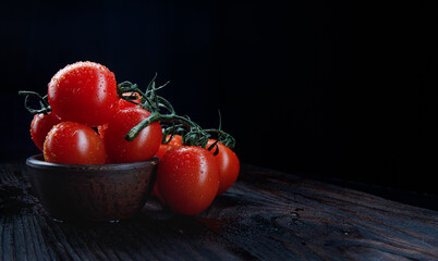 Wall Mural - Ripe red tomatoes on a dark background.