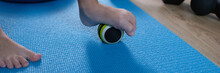 Child Foot Rests On Small Gymnastic Ball To Massage Feet Closeup