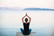© kite_rin - Young woman practicing yoga by the sea at sunset, Beautiful girl meditate outdoor, Harmony, meditation, healthy lifestyle and travel concept