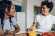 © Zamrznuti tonovi - African american couple having breakfast in the kitchen at home
