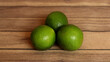 Lime or also called key lime comes from the Citrus aurantiifolia plant. Lime fruit is round, green, has a diameter of 3-6 centimeters, and contains an acidic liquid. lime on wooden background.