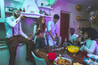 © oneinchpunch - A group of young people celebrating and making party at home