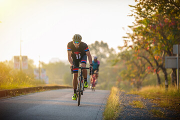 cyclist leads in action,Front view man riding bicycle in the racing road