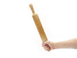 Woman hand holding a wooden rolling pin on a white background