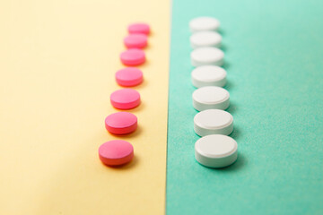 Wall Mural - White and pink medicines on a colored background