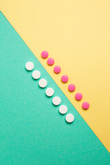 Wall Mural - White and pink medicines on a colored background