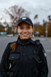 Portrait of smiling police woman on street