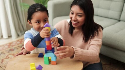 Wall Mural - Latin mother and kid having fun playing didactic games at home - Family time together