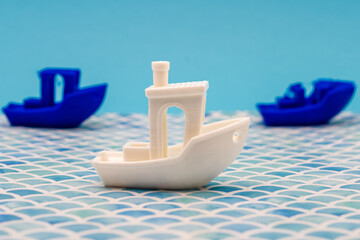 3d printed boats on blue backdrop