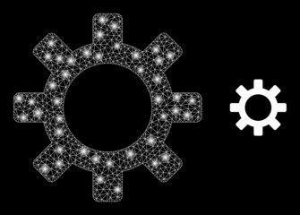 Wall Mural - Gearwheel icon and glowing mesh gearwheel model with sparkle spots. Illuminated model is generated using gearwheel vector icon and triangulated mesh. Glowing carcass gearwheel, on a black background.