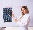 © Elnur - The young female doctor standing in front of the white board