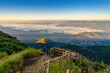Tropical forest nature landscape view with toursits mountain range and moving cloud mist at Kew Mae Pan nature trail, Doi Inthanon, Chiang Mai Thailand