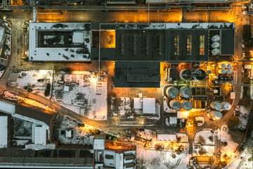 Wall Mural - Aerial view of a coal-fired power plant in the evening sending a power line to the city