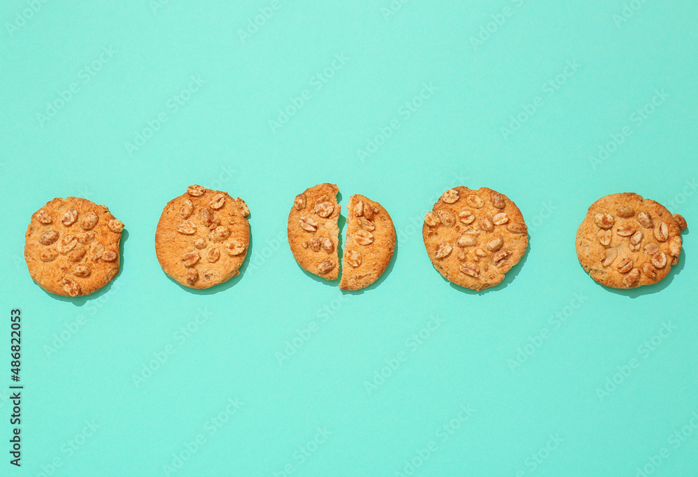 Tasty peanut cookies on turquoise background