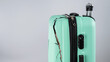 © Михаил Решетников - Close-up of a broken plastic suitcase on a white background.