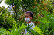 An Asian child wearing a funny face mask in the public garden to prevent transmission of the Omicron variant (Covid-19)