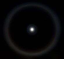 Moon Halo Phenomenon. Bright Ring Around The Moon Effect. Amazing And Mysterious Astronomical Phenomenon Over The Night Sky