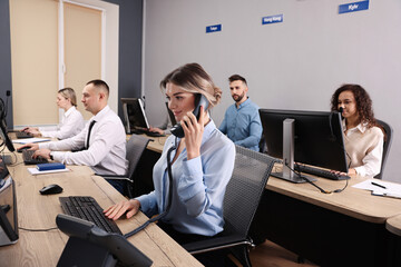 Wall Mural - Call center operators working in modern office